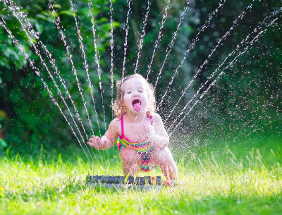 Thirsty Girl Playing in Sprinkler